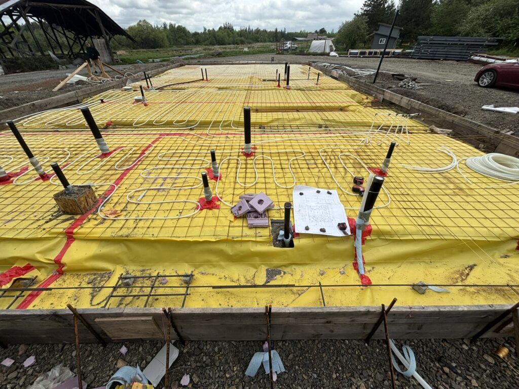 Under-slab plumbing and radiant floor heating installation for new construction