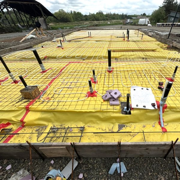 Under-slab plumbing and radiant floor heating installation before concrete slab placement