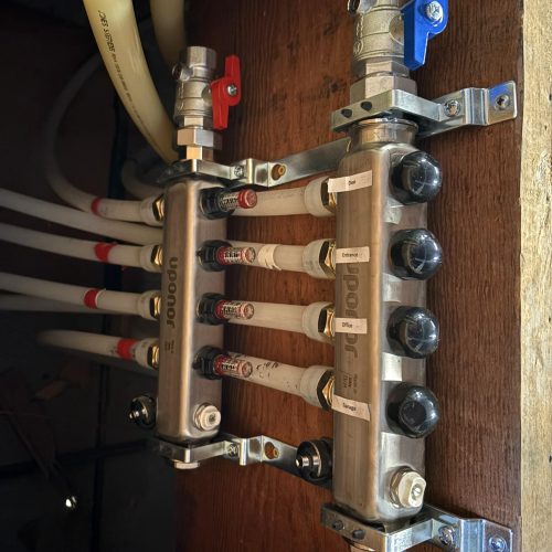 Uponor radiant floor heating manifold with labeled heating zones